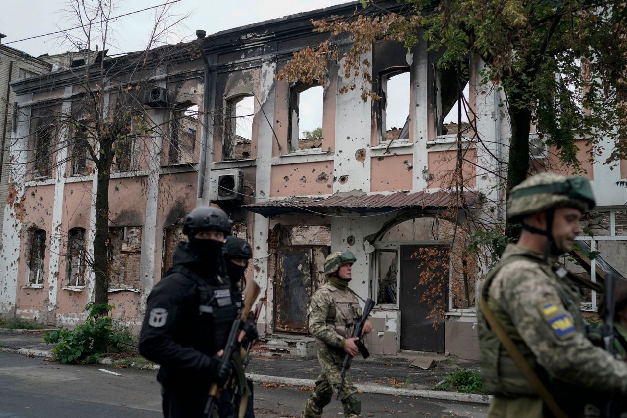 On the green ammunition box lie triangular letters with the symbol "Z", next to it — Russian school textbooks and a worn uniform with the patch "Russian Armed Forces". This is the archive of things collected after the liberation of Izium, a city that spent six months under occupation, often without water, gas, electricity, and communications.